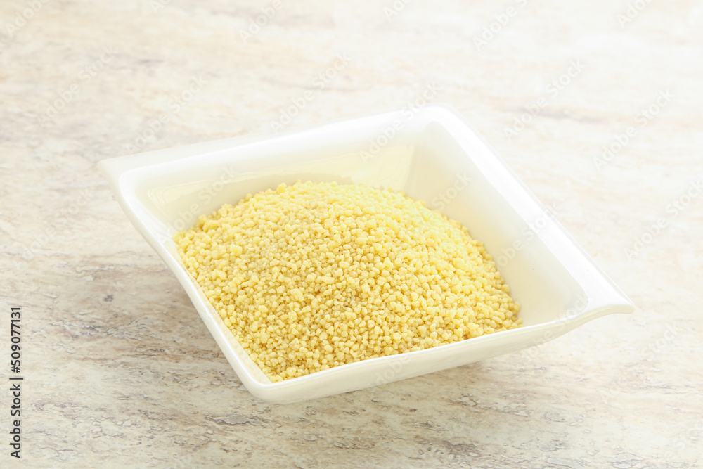 Raw couscous in the bowl Raw couscous in the bowl
