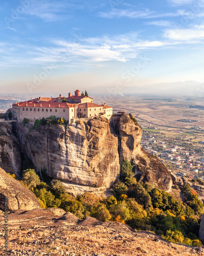 Old monastery built on top of a cliff in Meteora, Greece. Church on top of a mountain with view of city Kalambaka.
