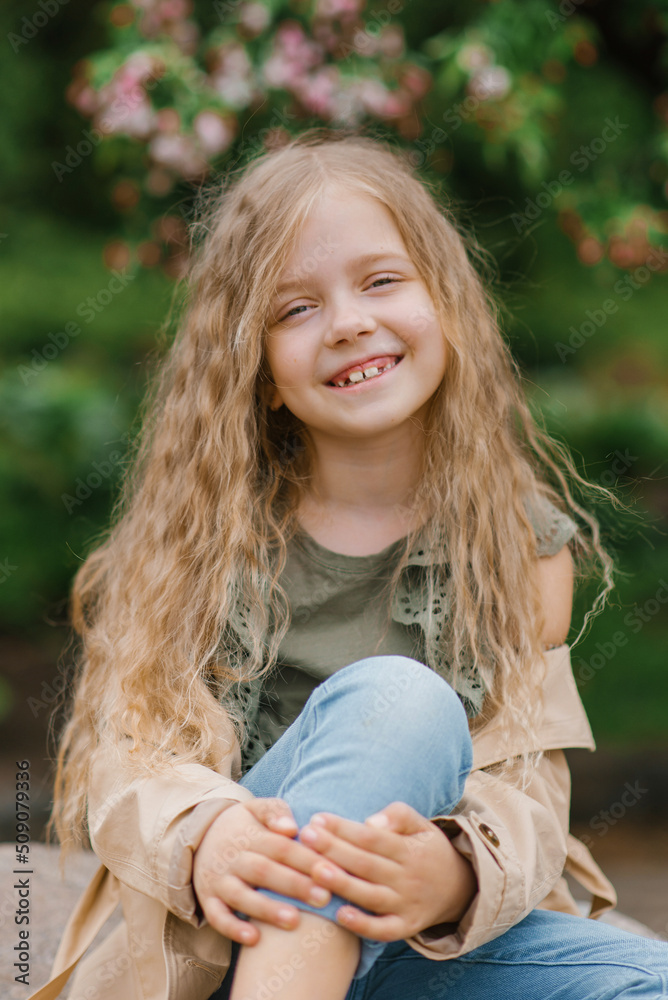Obraz premium Portrait of a happy smiling toothy seven-year-old girl with long brown hair