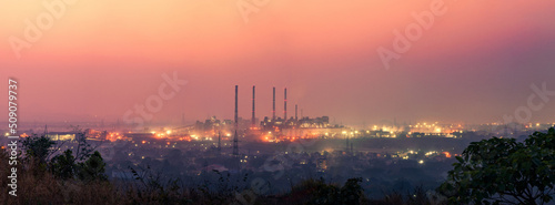 Panoramic industrial landscape. silhouette of an industry zone with factories and plants during sunset or sunrise