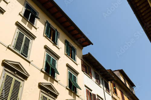 Facades with wooden window shutters in Florence, Italy