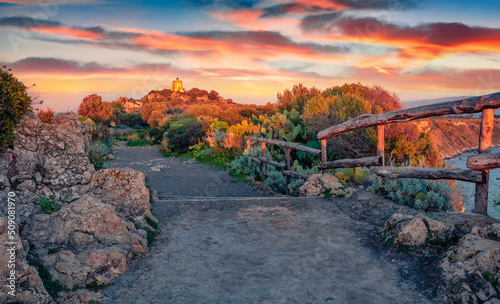 Attractive spring scene of Milazzo cape. Nice sunrise on nature reserve Piscina di Venere with old lighthouse, Sicily, Italy, Europe. Beauty of nature concept background.