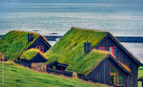 Kirkjubour village with turf-top houses, Faroe Islands,  Denmark, Europe. Extraordinary morning scene of Hestur Island. Architectural background.. photo
