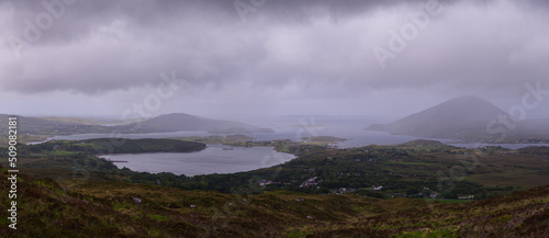 scenic panoramic vista over Connemara National Park with low dark rain clouds in Spring