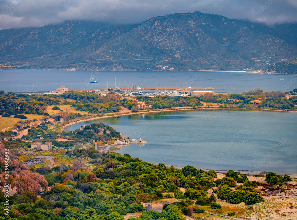 Fototapeta premium Gloomy summer view of Villasimius port. Aerial morning scene of Sardinia island, Italy, Europe. Spectacular seascape of Mediterranean sea. Traveling concept background.