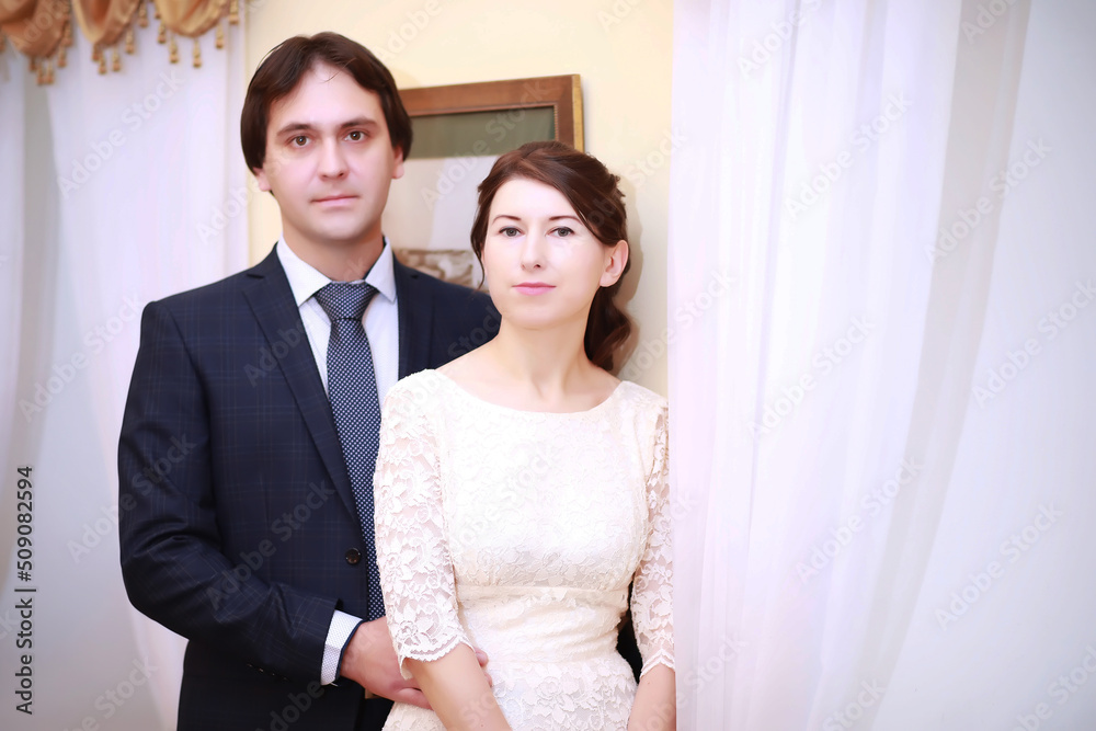Portrait of emotional lovers of brides indoor.Bride and groom kisses tenderly . Emotional photo of a couple in love on the wedding day. Portrait of emotional lovers of brides indoor.Bride and groom kisses tenderly . Emotional photo of a couple in love on the wedding day.