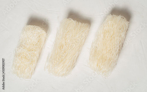 raw Korean starch noodles tanmen on a gray background, top view.