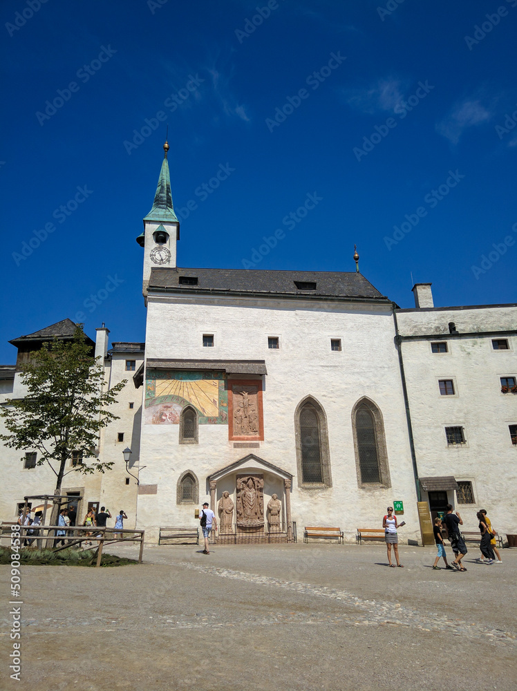 Salzburg, Austria - August 26, 2019: Beautiful view of St. George's Chapel in Hohensalzburg Fortress, Salzburg. Tourists walk and take photos. Copy space. Vertical