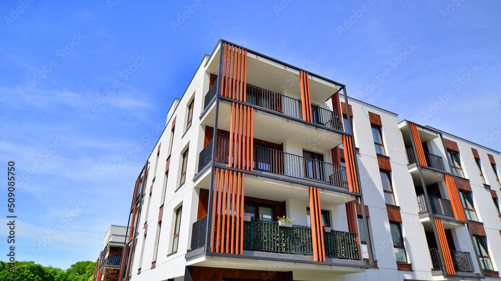 Obraz premium Apartment residential house and home facade architecture and outdoor facilities. Blue sky on the background. Sunlight in sunrise.