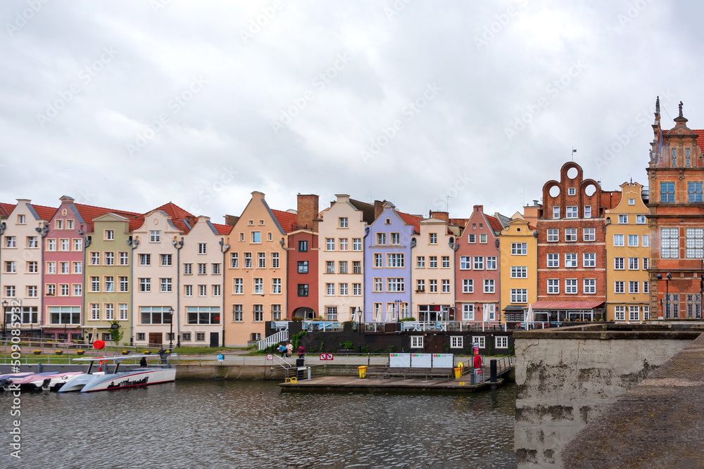 Historic Old Town of Gdansk in Poland, colourful houses on embankment in rainy weather.