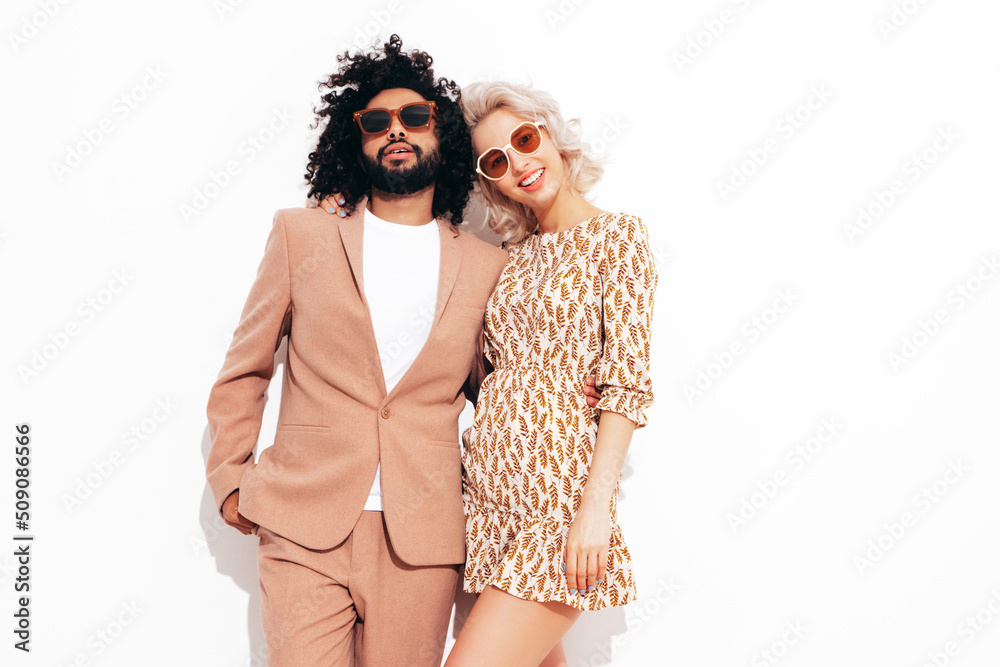 Smiling beautiful woman and her handsome boyfriend. Sexy cheerful multiracial family having tender moments on white background in studio. Multiethnic models hugging. Embracing each other.Love concept Smiling beautiful woman and her handsome boyfriend. Sexy cheerful multiracial family having tender moments on white background in studio. Multiethnic models hugging. Embracing each other.Love concept