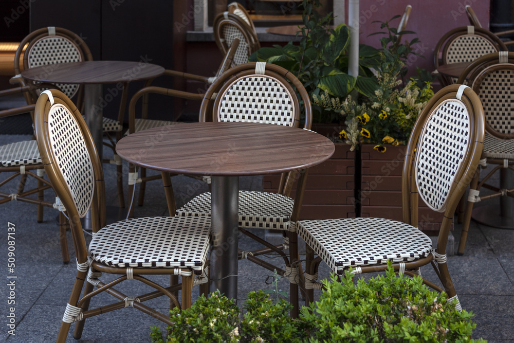 Empty table in outdoor cafe or restaurant. Tables and chairs at sidewalk cafe. Touristic setting, cafe table, sidewalk cafe furniture.