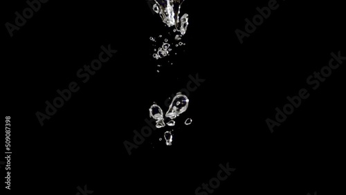 Super slow motion, water droplets fall into the water with air bubbles on a black background. Filmed on a high-speed cinema camera at 1000 fps. Stduio Shot, High quality Full HD footage. photo