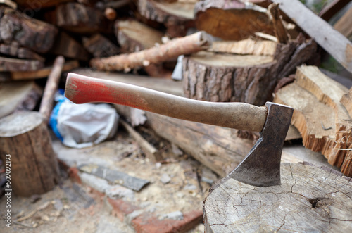 Ax in the stump. Axe for cutting wood. Preparation of firewood for the winter. Selective focus, blurred background