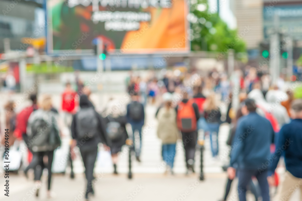 People crossing street in city, blurred view