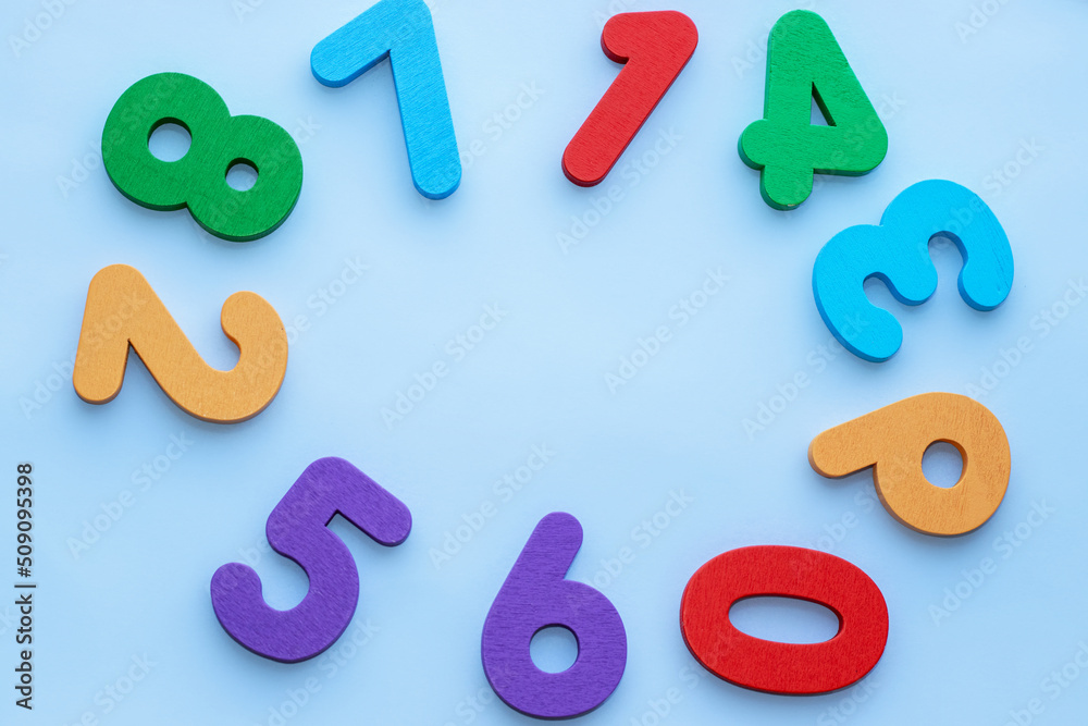 wooden eco numbers toys placed like a clock shape,circle,free space in the middle.education,learning concept.back to school.light blue background wooden eco numbers toys placed like a clock shape,circle,free space in the middle.education,learning concept.back to school.light blue background
