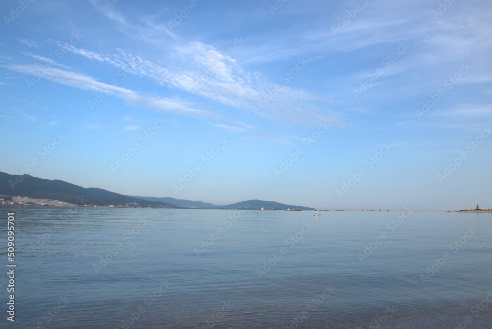 High blue sky, clear sea water, proud mountains. Embankment of Novorossiysk. Krasnodar Region. Russia.