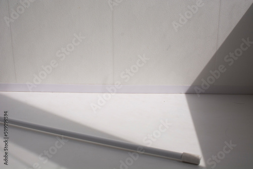 a white stick on a white background and shadows. light and shadow