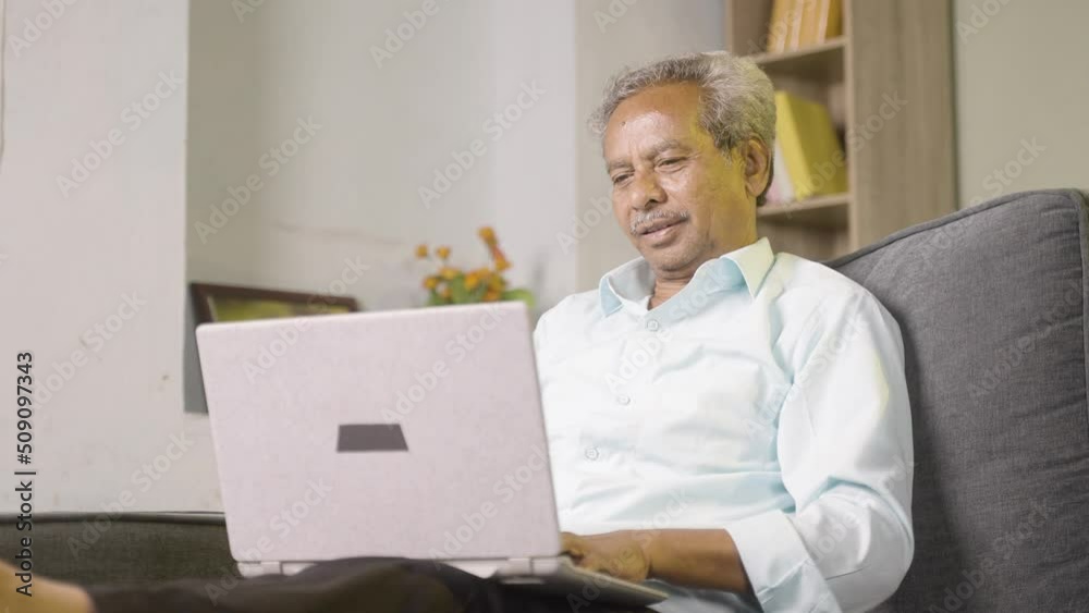 elerly old man busy working on laptop at home while sitting on sofa - concept of workplace, technology and lifestyle elerly old man busy working on laptop at home while sitting on sofa - concept of workplace, technology and lifestyle