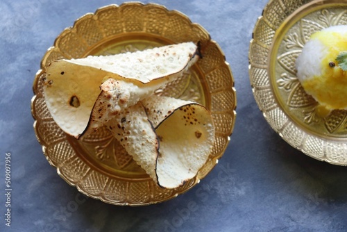 Urad dal roasted papad. It is an Indian crispy popular snack that is a side dish for lunch and dinner. Roasted roll papad with copy space. Perfect to have it with Dal rice. photo