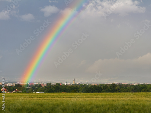 City Ceske Budejovice with storm cloud sky, rainbow and barley filed. Czech republic