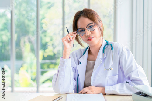 Smiling asian female doctor in the office , Portrait of beautiful mature woman doctor is committed to treating patients. healtcare and assistance concept