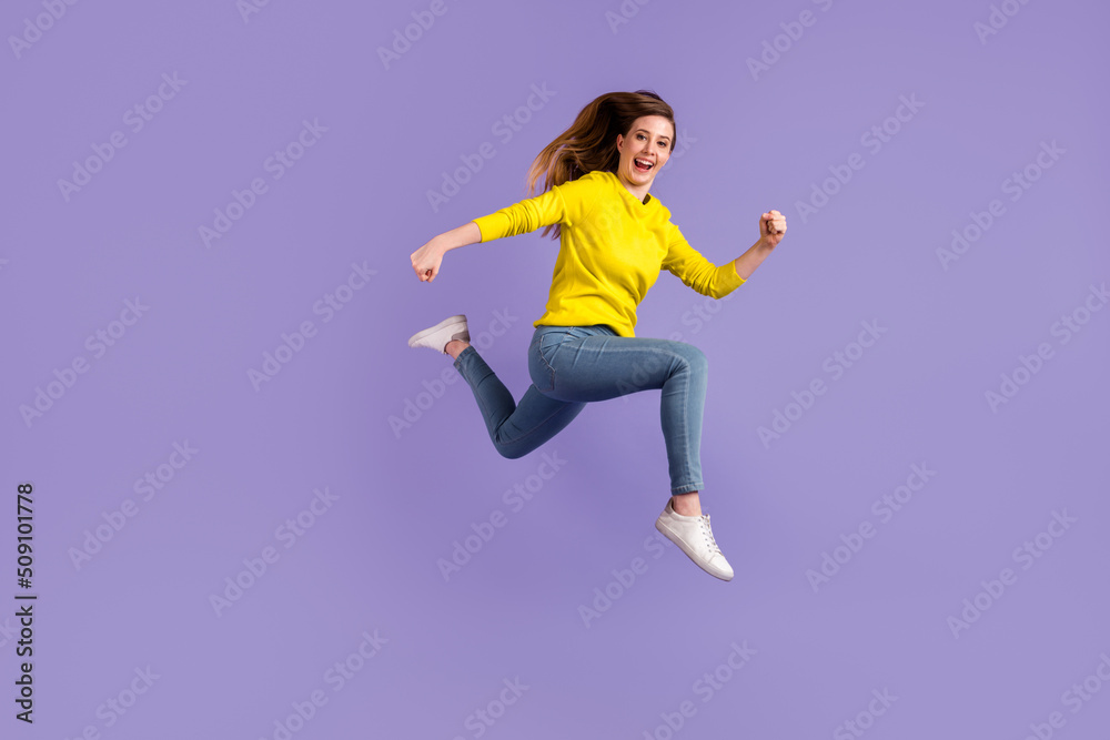 Full size profile side photo of young excited girl runner jumper hurry isolated over purple color background