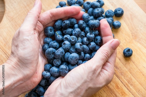 Food healthy blueberry berry organic. vegetarian harvest. A woman sprinkles blueberries with her hands.
