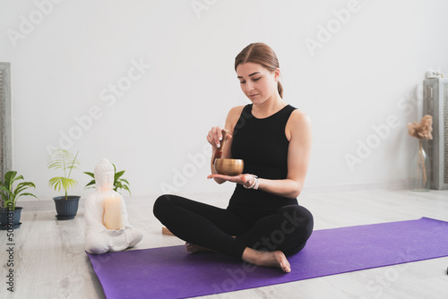 Portrait of a female yogi with a singing bowl