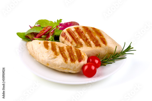 Chicken breast grilled meat, with vegetables and greens on a white plate, isolated on white background.