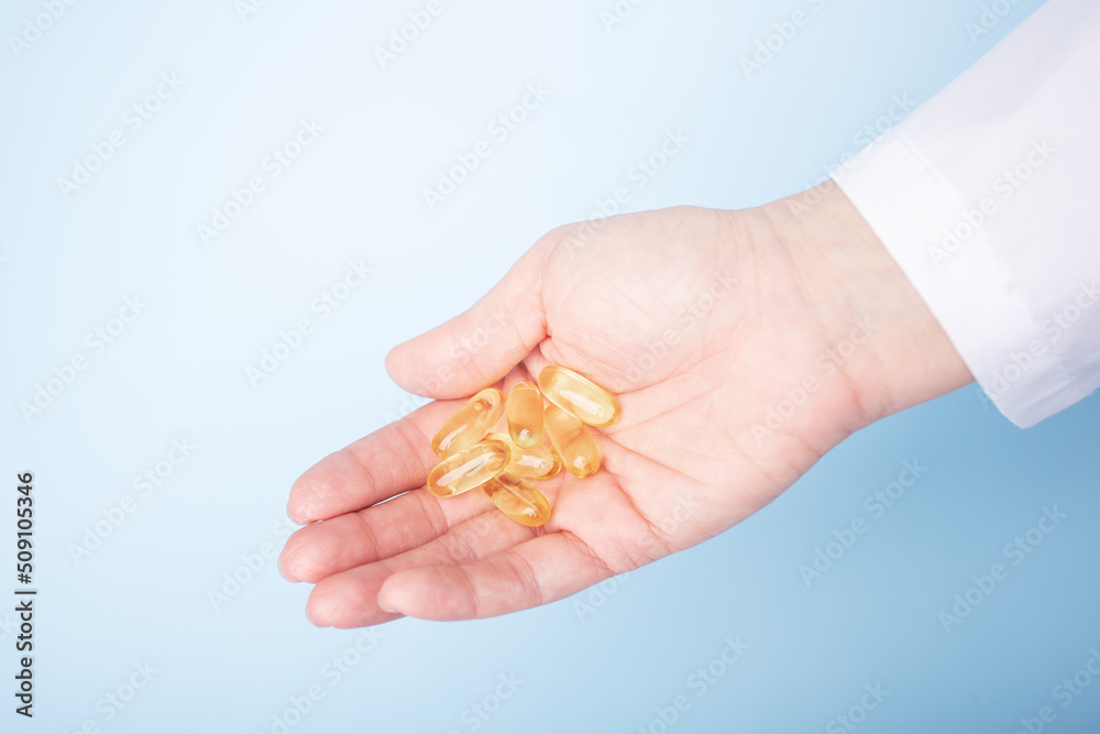 fish oil, medicine pills in doctor's hand