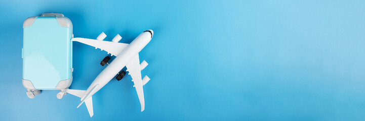 travel and transportation industry, airplane tickets, international flights, plane and luggage on a blue background with copy space, summer holidays and vacations,banner