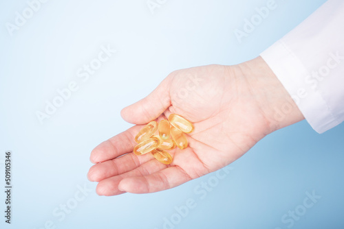 fish oil, medicine pills in doctor's hand