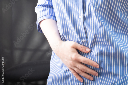 constipation, diarrhea, indigestion, pain in the abdomen, diseases of the stomach and intestines, poisoning, a woman holds her stomach with her hand