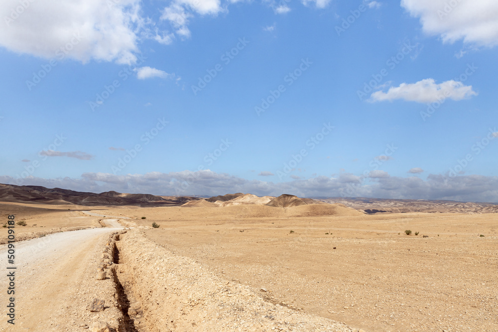Road through the stone desert near the Khatsatson stream, on the Israeli side of the Dead Sea, near Jerusalem in Israel Road through the stone desert near the Khatsatson stream, on the Israeli side of the Dead Sea, near Jerusalem in Israel