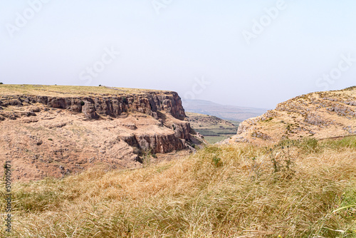 Overgrown  with grass and bushes, the slope of Mount Arbel, located on the shores of Lake Kinneret - the Sea of Galilee, near the city of Tiberias, in northern Israel. photo