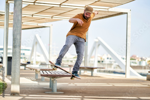 a young man skateboarding on a bank near the harbor © Retamosa