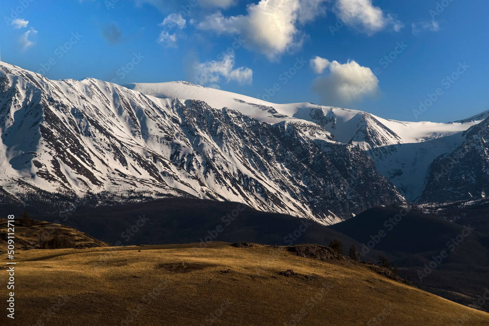 North Chuya Ridge. Evening sky with beautiful clouds. Kurai steppe. Altai Mountains, Russia North Chuya Ridge. Evening sky with beautiful clouds. Kurai steppe. Altai Mountains, Russia