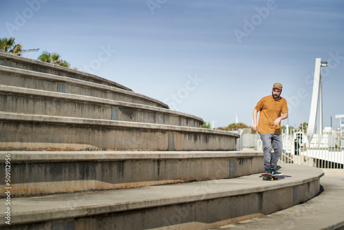A young man skating on a bleachers