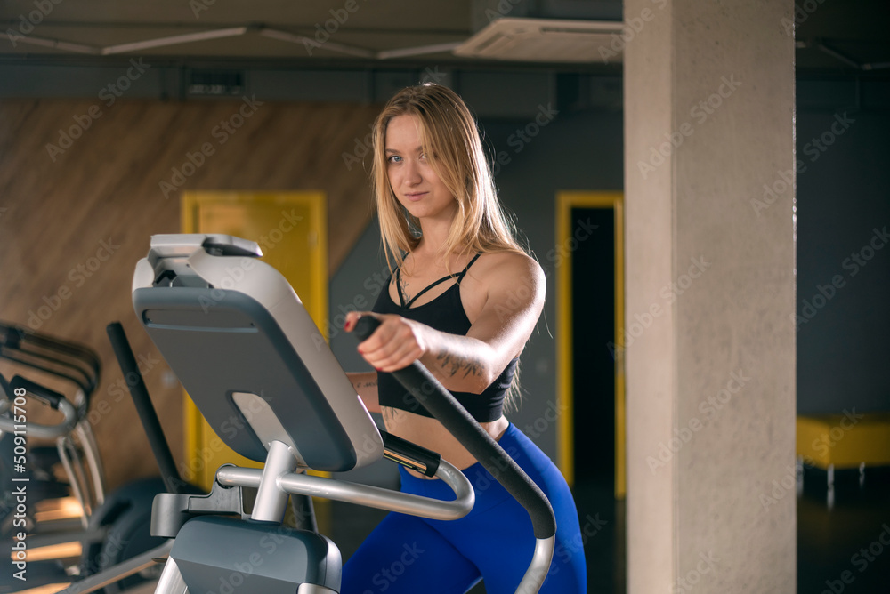 Fit girl in aerobics class. Lady doing workout in modern gym. Sexy muscular female with slim body running in empty gym. Fit girl in aerobics class. Lady doing workout in modern gym. Sexy muscular female with slim body running in empty gym.