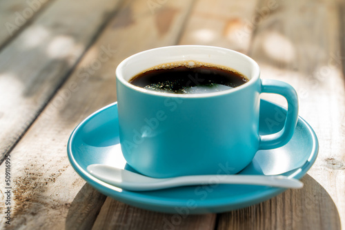blue ceramic coffee cup on the old wooden floor.
