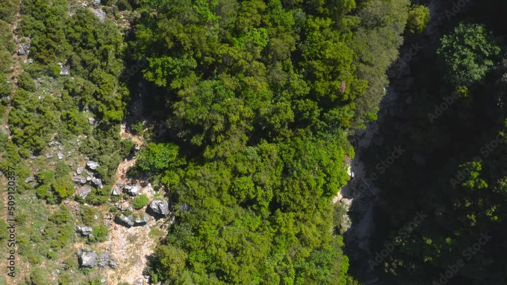 Hikers trekking along remote meadow on the Llogara National Park, Albanian mountains. Bird eyes view Hikers trekking along remote meadow on the Llogara National Park, Albanian mountains. Bird eyes view