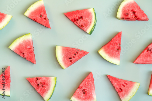 Ripe pieces of watermelon. Green summer background.