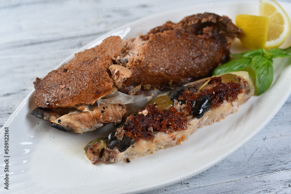grilled fish with sun-dried tomatoes and olives
