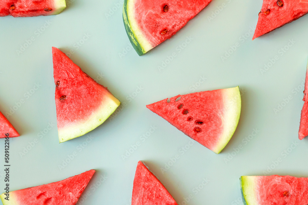 Fresh watermelon slices on green background. Summer fruits pattern. Fresh watermelon slices on green background. Summer fruits pattern.