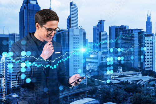 Photography Handsome eastern trader checking quotes to forecast the capital market behavior