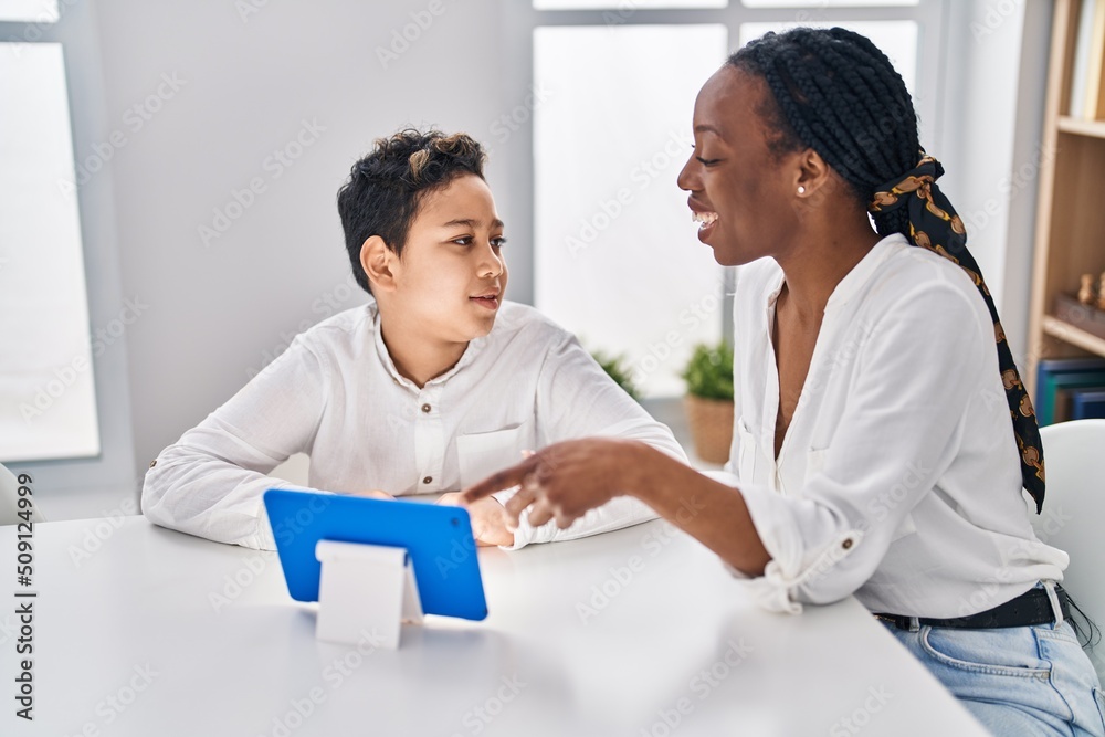 African american mother and son watching video on touchpad at home African american mother and son watching video on touchpad at home