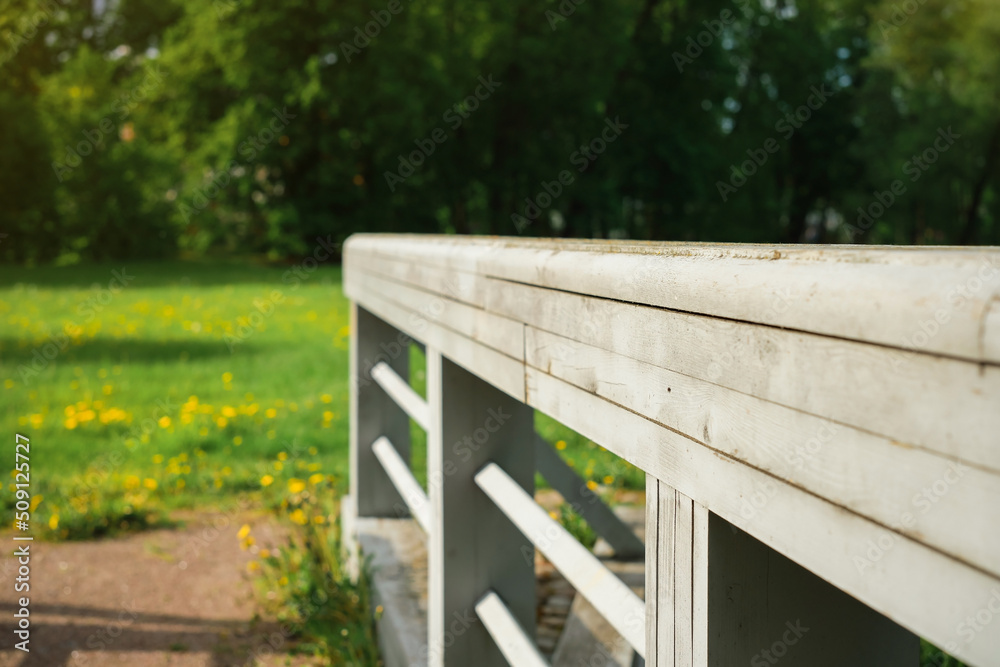 Natural background, the railing of an old bridge in front of the forest, if the selective focus is on the railing. Summer walks in nature, travel on vacation Natural background, the railing of an old bridge in front of the forest, if the selective focus is on the railing. Summer walks in nature, travel on vacation