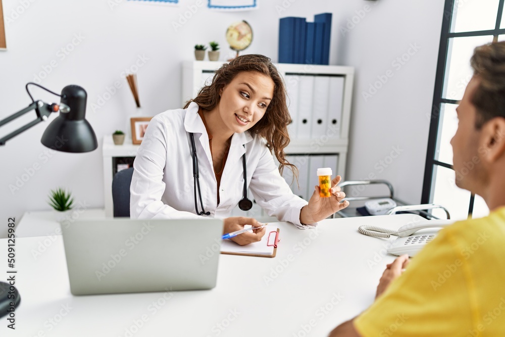 Man and woman having doctor visit prescribing pills at clinic Man and woman having doctor visit prescribing pills at clinic
