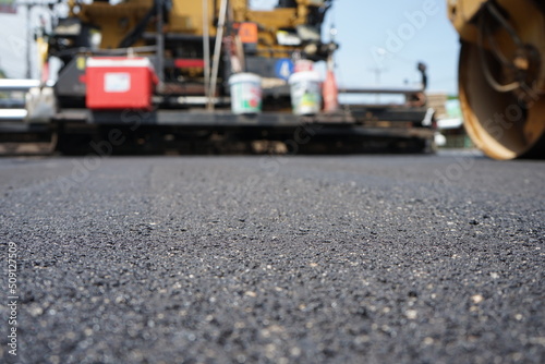 The image is blurred in the construction of asphalt road.